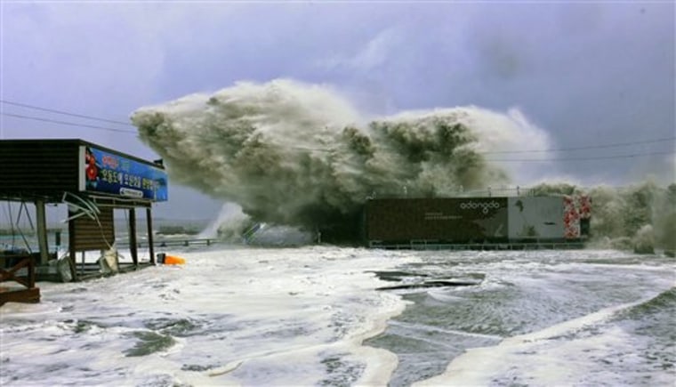 In this photo released by Yeosu City and distributed via Yonhap News Agency, high waves caused by Typhoon Sanba crash on beach in Yeosu, south of Seoul, South Korea on Monday.